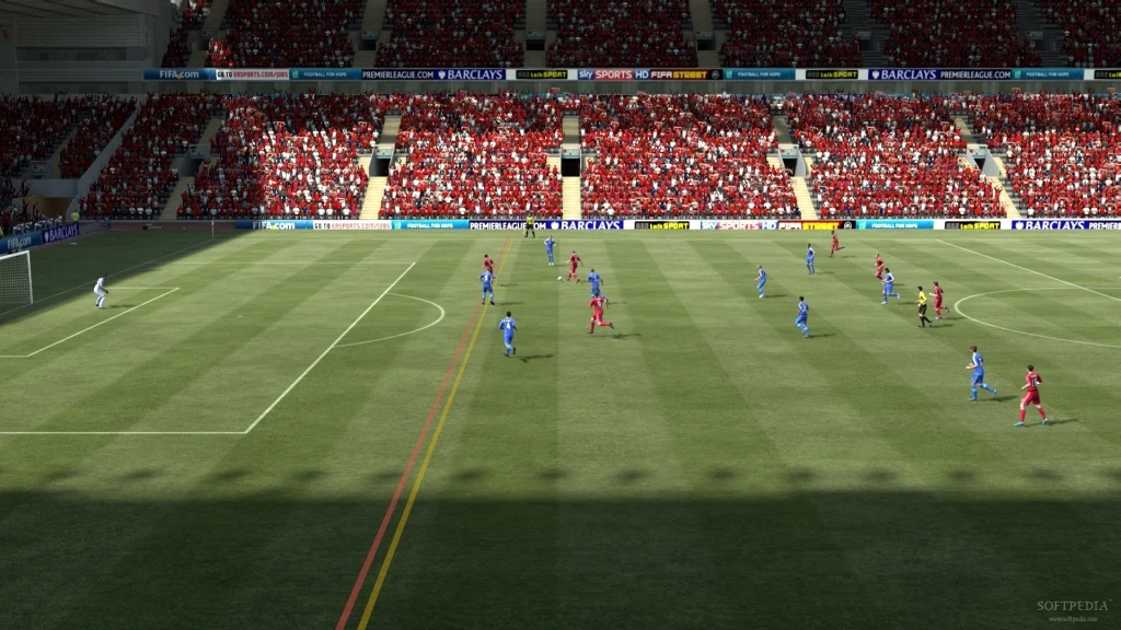 Partida de FIFA 12 entre equipes de vermelho e azul, vista da câmera de transmissão