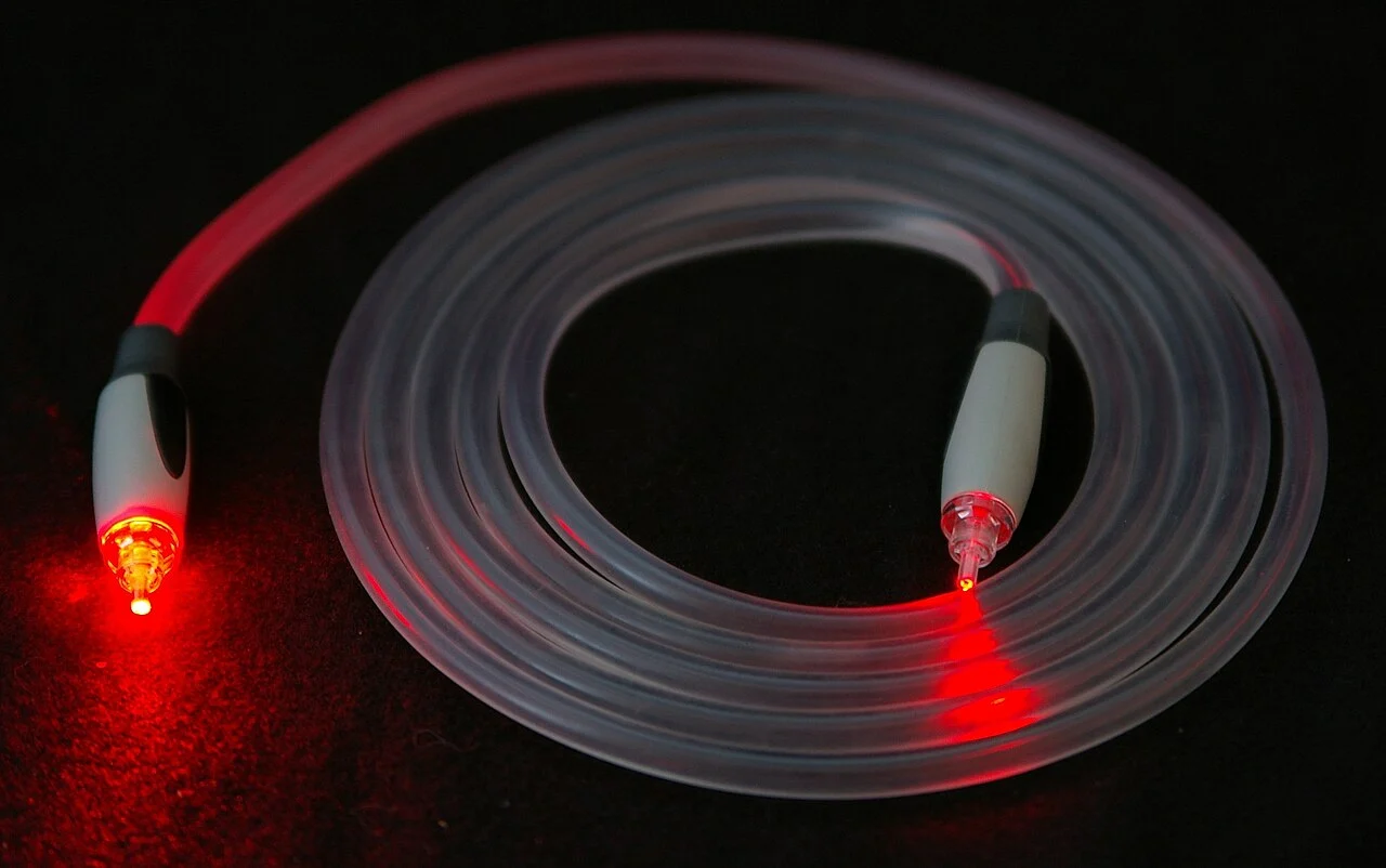 Cabo de fibra óptica iluminado representando conexão de internet por fibra