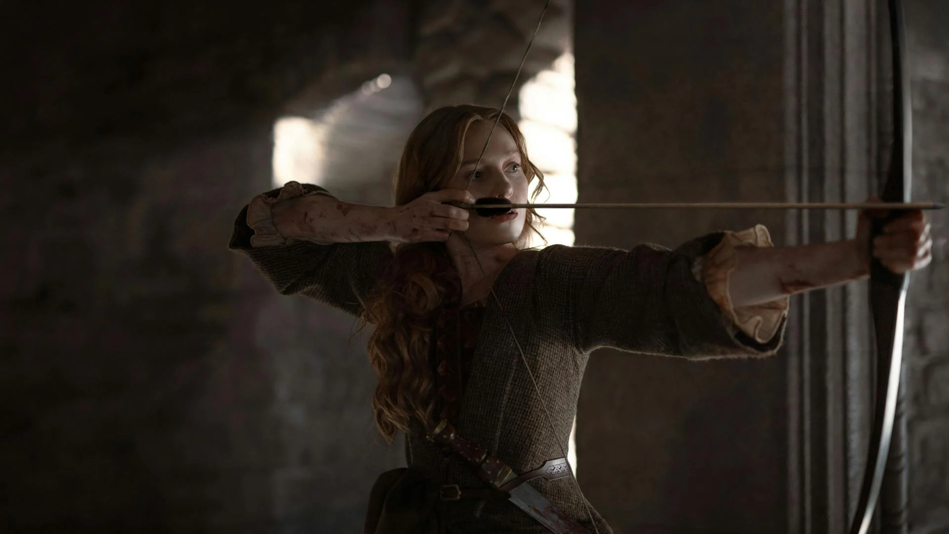 Ellen MacKenzie, interpretada por Harriet Slater, aponta um arco em Outlander: Blood of My Blood