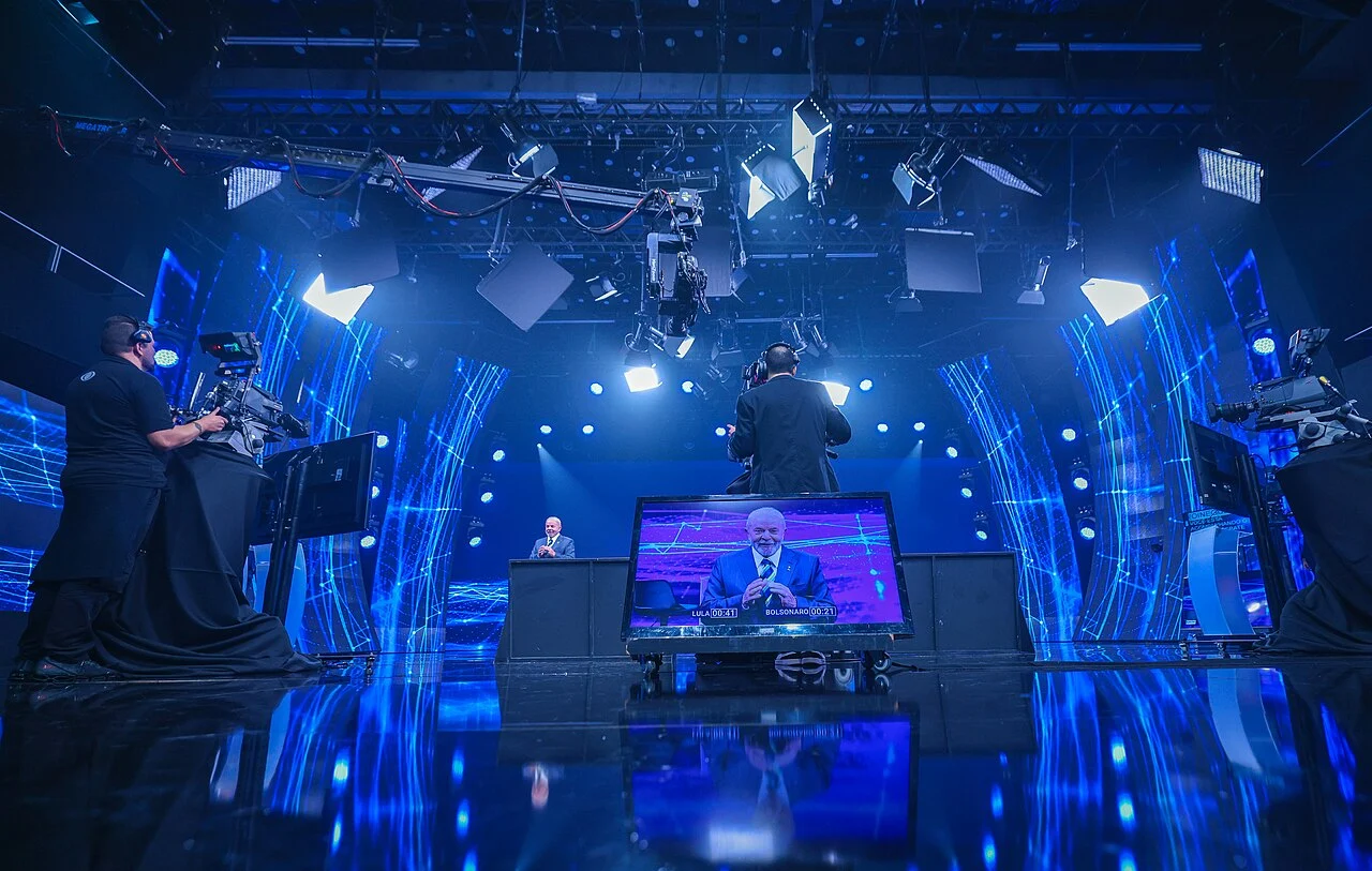 Visão ampla do estúdio da Band durante o debate presidencial de 16 de outubro de 2022, com câmeras e monitor da transmissão