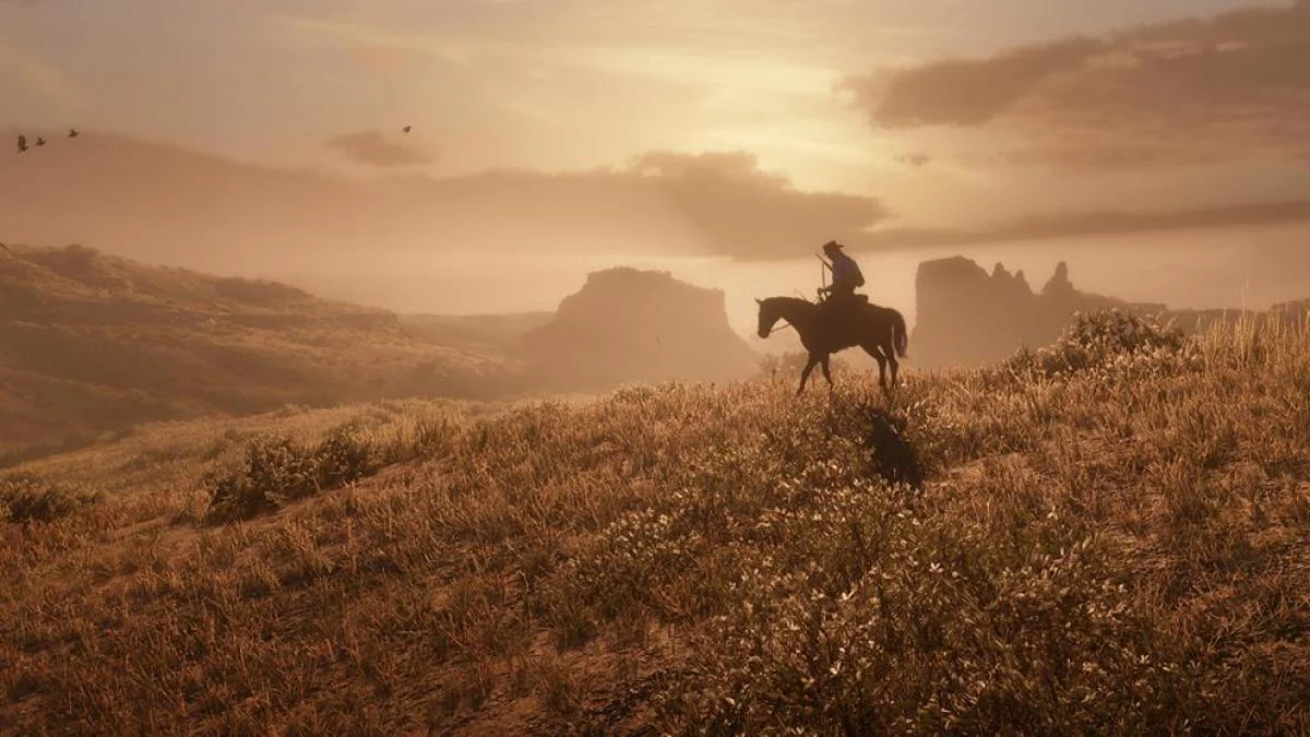 Arthur Morgan cavalgando ao pôr do sol no mundo aberto de Red Dead Redemption 2