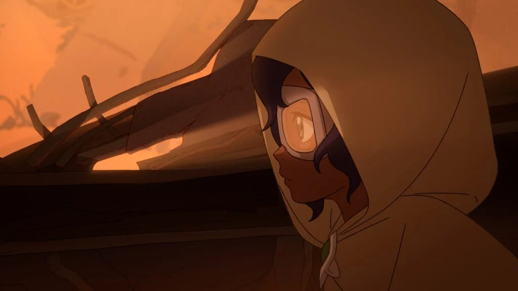 Pavi aparece encapuzada diante de um cenário de destruição em Avatar Seven Havens